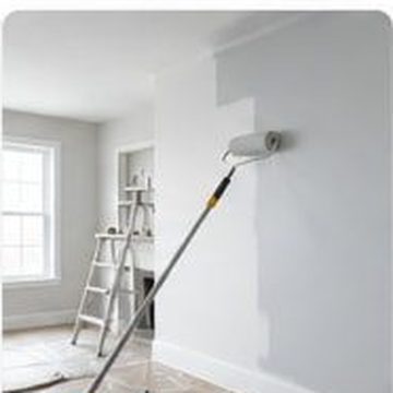 Roller applying fresh paint to an interior wall